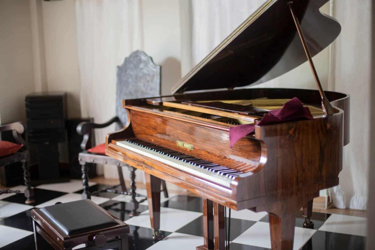 Beautiful wooden grand piano with open lid in a sophisticated room with elegant decor.