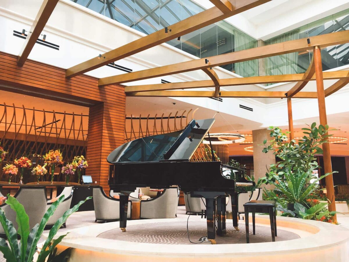 An elegant hotel lobby in Manila featuring a grand piano and modern interior design elements.